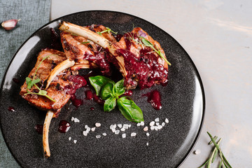 Grilled ribs with red sauce on the wooden background