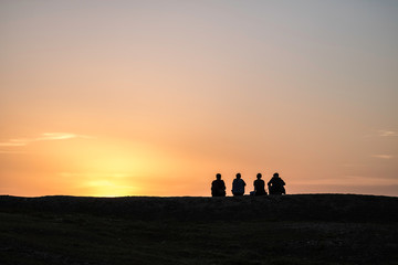 Silhouttes in sunset on hill