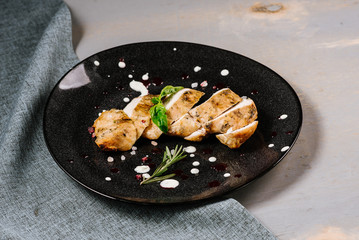 Roasted meat pieces with spices on the wooden background