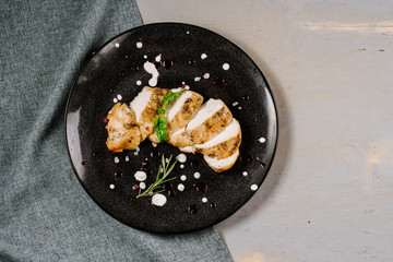 Roasted meat pieces with spices on the wooden background