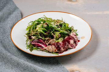 Fresh tasty green salad on the wooden background