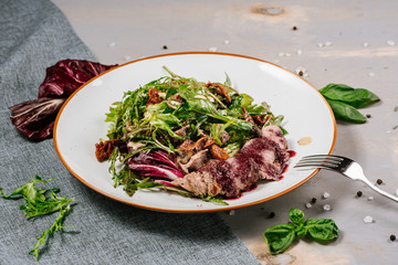 Fresh tasty green salad on the wooden background