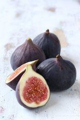 Fig fruit on a white woode nbackground