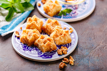 Ramadan Kareem holiday table with nuts and baklava. Eastern abundance.