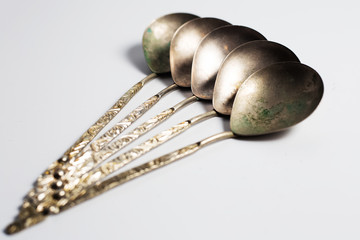 Collection of ancient spoons. On background of white.