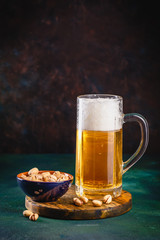 Mug of beer on dark background