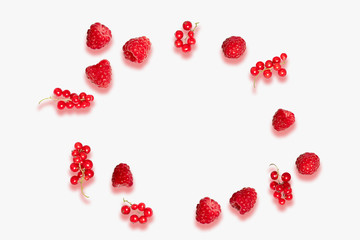 Background with red berries of raspberries and currants on a light plain background for use on a banner, poster or postcard