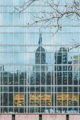 Obraz premium New York City, NY, USA - December, 2018 - Streets of Manhattan, Skyline view reflected like a mirror in a building in front of Bryant Park.