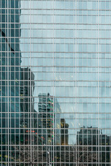 New York City, NY, USA - December, 2018 - Streets of Manhattan, Skyline view reflected like a mirror in a building in front of Bryant Park.