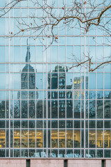 New York City, NY, USA - December, 2018 - Streets of Manhattan, Skyline view reflected like a mirror in a building in front of Bryant Park.