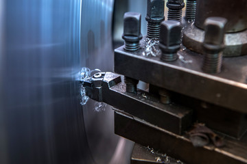 Fototapeta na wymiar Lathe is turning with cutting tools in the process of repairing metal parts in industrial plants.