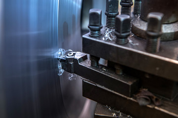 Lathe is turning with cutting tools in the process of repairing metal parts in industrial plants.