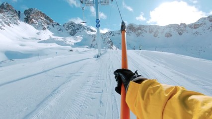 Snowboard or ski rider on drag lift pov