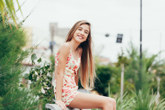 Outdoor portrait of 12 years old girl with long hair