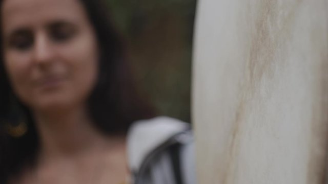 Shaman woman drumming