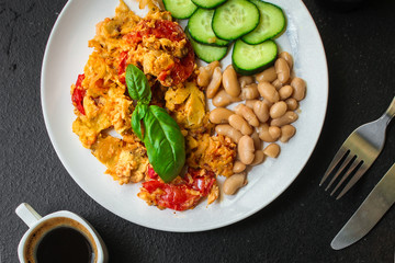 scrambled eggs with tomatoes - breakfast delicious and healthy, menu concept. food background. copy space