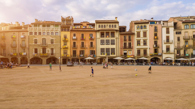 Fototapeta Vic Catalonia Spain Placa Major Main Square . Golden light. Summer time. People walking streets. Street life photo