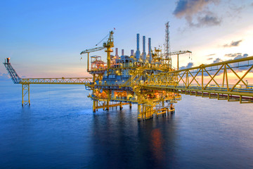 Large Offshore oil rig drilling platform at sunset and beautiful sky in the gulf of Thailand