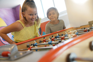 Kids having fun playing foosball