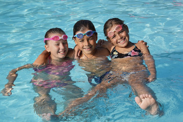Cheerful group of kids at the swimming-pool