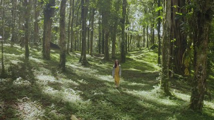 Aerial view of young woman walk in forest