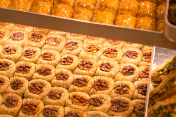 Traditional delicious turkish dessert baklava in the shop window showcase. Different kinds of turkish delights. Popular souvenirs and snacks from Turkey.