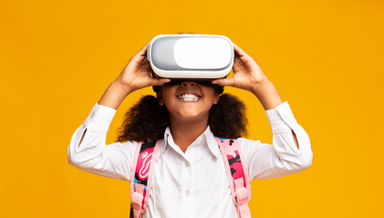 Afro Elementary Student Girl Using VR Headset, Yellow Background