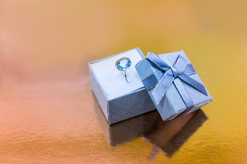 Beautiful ring with topaz in gift box close up