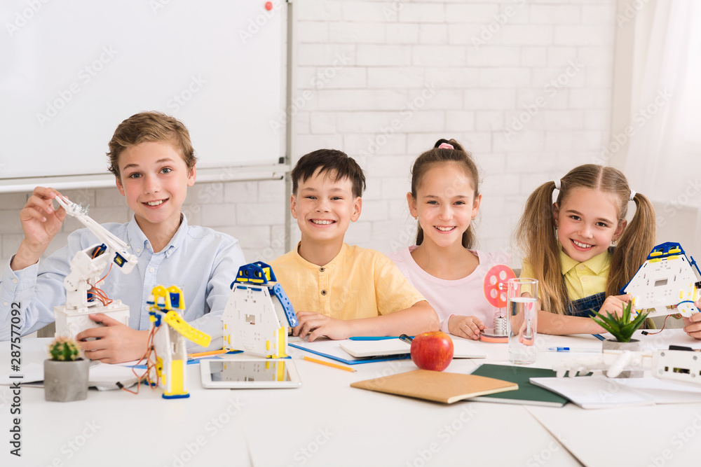 Poster Happy children creating robots at stem class