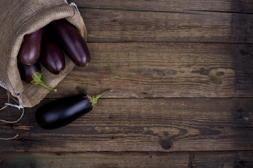 Fresh healthy eggplants on white wooden background. canvas, linen, scrim, cloth, sackcloth, crash
