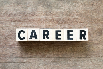 Letter block in word career on wood background