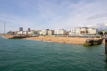 Obraz premium Brighton UK, 10th July 2019: The famous beautiful Brighton Beach and Seafront showing the coastline area on a bright sunny day,