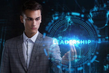 The concept of business, technology, the Internet and the network. A young entrepreneur working on a virtual screen of the future and sees the inscription: Leadership