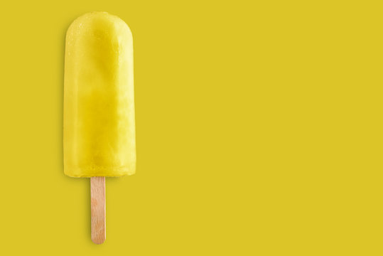 lemon popsicle on yellow background