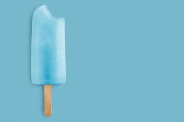 cool bitten popsicle on blue background