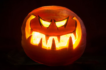 Halloween pumpkin smile and scrary eyes for party night. Black background