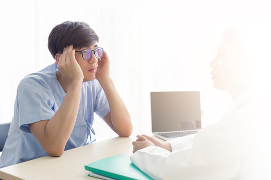 Young Asian patient men talking with the doctor in the hospital, health care concept.