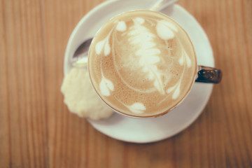 hot cappuccino coffee latte on wood table.