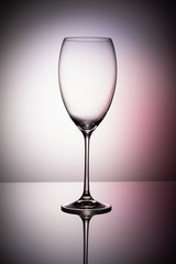 Empty wine glass goblets on a colored purple background abstract