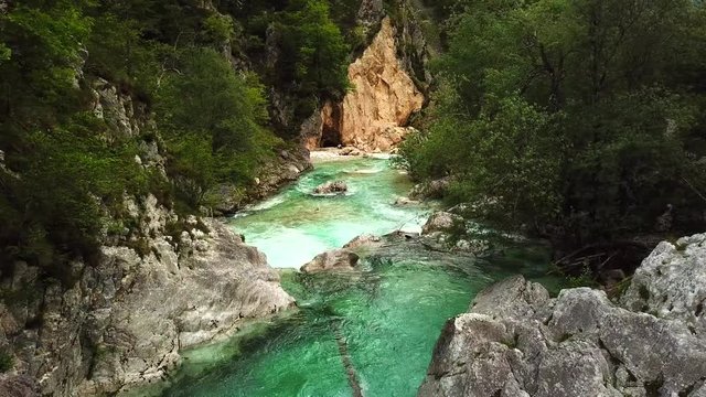 Forward drone shot above a slovenian river flowing in a gorge