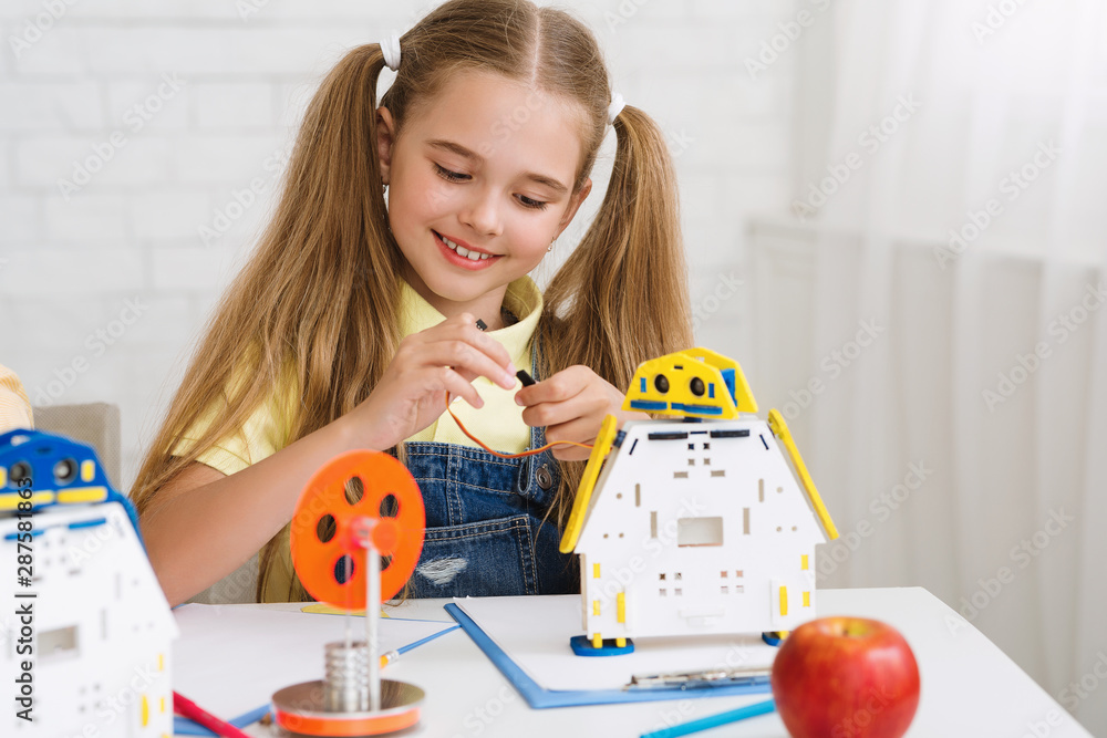 Poster stem education. school girl constructing robot at lesson