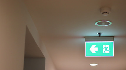 Emergency exit sign illuminated in the building.