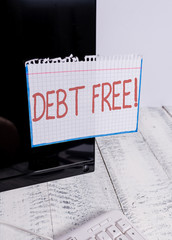 Text sign showing Debt Free. Business photo text does not owning any money or things to any individual or companies Notation paper taped to black computer monitor screen near white keyboard