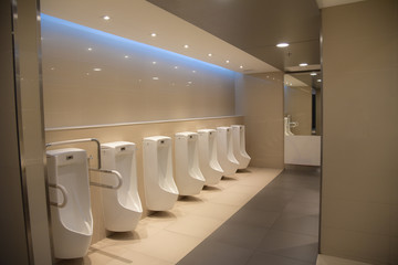 Row of white urinals men public toilets