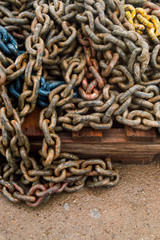 Anchor chain over an old pallet in the port.