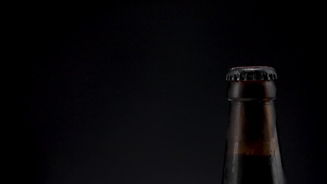 beer bottle on black background closeup. copy space