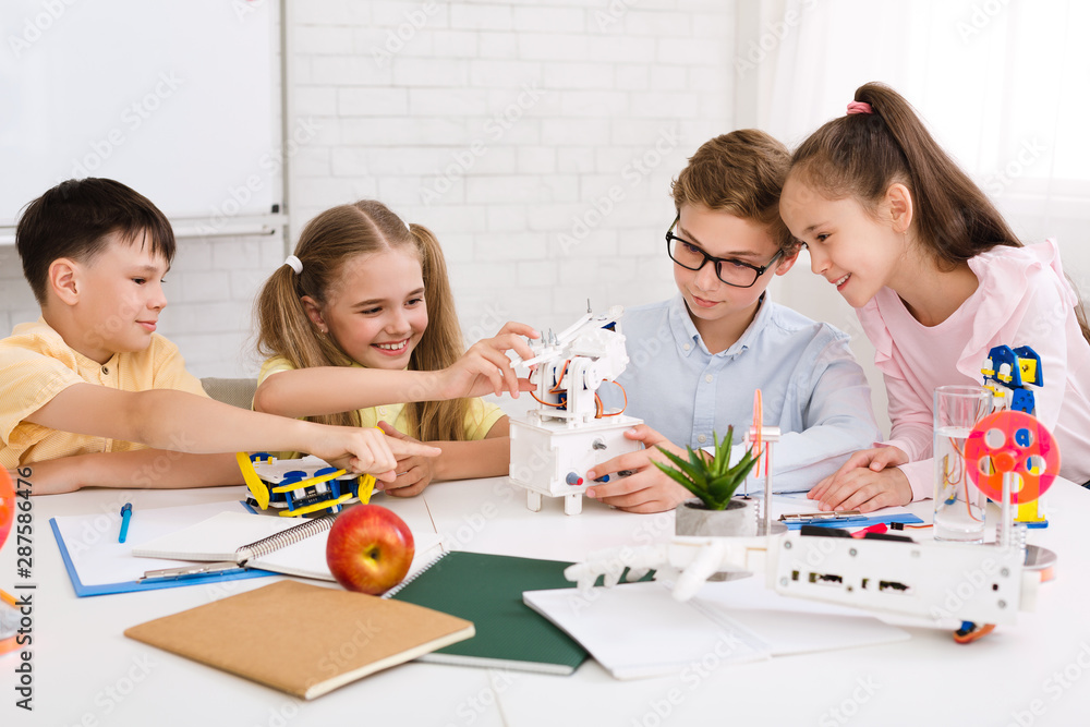 Poster Children constructing robotic device at stem class