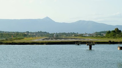 Passenger airplane flying in the sky. Aircraft taking off from runway at the airport of Corfu. Greece. 4K