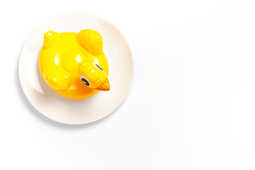 Inflatable mini yellow chicken or duckling on white plate on white background. Creative food concept, tobacco chicken. Flat lay copy space. Trend Inflatable Children toy for swimming Layout for design