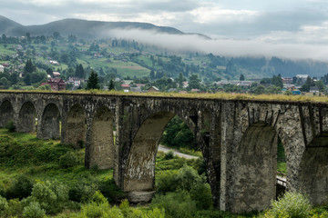 Fototapeta na wymiar Old viaduct in the village of Vorokhta. Ukraine, Carpathians.